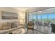 Cozy living room with comfortable seating, large sliding glass doors to a screened patio, and beautiful view of the beach at 6951 Gulf Of Mexico Dr # 14, Longboat Key, FL 34228