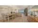 Bright living area with dining, beach views from sliding doors, and updated, light wood-look floors at 6951 Gulf Of Mexico Dr # 14, Longboat Key, FL 34228