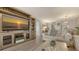 Living room with entertainment center, comfortable seating, and view into the dining area at 6951 Gulf Of Mexico Dr # 14, Longboat Key, FL 34228