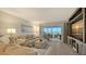 Cozy living room featuring a comfortable sofa, neutral decor, and balcony access with beach view at 6951 Gulf Of Mexico Dr # 14, Longboat Key, FL 34228