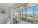 Relaxing screened patio overlooking beach with ocean views, ceiling fan, and tile flooring at 6951 Gulf Of Mexico Dr # 14, Longboat Key, FL 34228