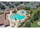 An aerial view of the community swimming pool and tennis courts at 7019 Grand Estuary Trl # 101, Bradenton, FL 34212