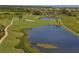 Community aerial view showcasing winding cart paths, lush landscaping, lake, and golf course at 7019 Grand Estuary Trl # 101, Bradenton, FL 34212