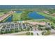 Expansive aerial view of the community featuring lakes, pools, tennis courts, and beautifully landscaped grounds at 7019 Grand Estuary Trl # 101, Bradenton, FL 34212