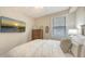 Comfortable bedroom features natural light, a dresser, and a relaxing beach-themed decor at 7019 Grand Estuary Trl # 101, Bradenton, FL 34212