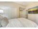 Cozy bedroom features white walls, carpet and a large TV for relaxing and unwinding at 7019 Grand Estuary Trl # 101, Bradenton, FL 34212