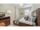 Inviting bedroom with warm wood accents, soft textures and ample natural light at 7019 Grand Estuary Trl # 101, Bradenton, FL 34212