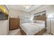 Cozy bedroom with a queen-size bed, dresser, and a window offering natural light for a comfortable space at 7019 Grand Estuary Trl # 101, Bradenton, FL 34212