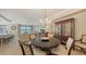 Dining area showcasing an elegant chandelier, modern furniture, and an open layout at 7019 Grand Estuary Trl # 101, Bradenton, FL 34212
