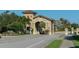 Elegant community entrance with stone accents, lush landscaping, and a welcoming gatehouse at 7019 Grand Estuary Trl # 101, Bradenton, FL 34212
