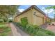 Well-maintained exterior of a townhome featuring lush landscaping and a brick walkway at 7019 Grand Estuary Trl # 101, Bradenton, FL 34212