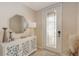 Inviting foyer with a decorative glass door, stylish console table, and modern decor at 7019 Grand Estuary Trl # 101, Bradenton, FL 34212