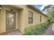Elegant front entrance showcasing a decorative glass door and manicured landscaping at 7019 Grand Estuary Trl # 101, Bradenton, FL 34212