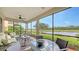 Relaxing screened lanai with comfortable seating overlooking a lush golf course and pond at 7019 Grand Estuary Trl # 101, Bradenton, FL 34212