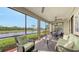 Inviting screened lanai features comfortable seating and scenic views of the golf course and pond at 7019 Grand Estuary Trl # 101, Bradenton, FL 34212