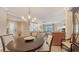Bright and airy living space featuring a large dining table, opening to a modern living room at 7019 Grand Estuary Trl # 101, Bradenton, FL 34212