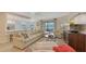 Spacious living room with a comfortable sofa, modern decor, and access to an outdoor seating area at 7019 Grand Estuary Trl # 101, Bradenton, FL 34212