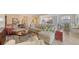 Open concept living room with comfortable seating, view of the kitchen and breakfast nook at 7019 Grand Estuary Trl # 101, Bradenton, FL 34212