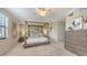 Spacious main bedroom featuring a four-poster bed, soft lighting, and neutral decor for relaxation at 7019 Grand Estuary Trl # 101, Bradenton, FL 34212