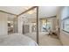 Comfortable main bedroom with a private balcony, en-suite bathroom, and seamless flow to the living spaces at 7019 Grand Estuary Trl # 101, Bradenton, FL 34212