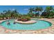 A community swimming pool with a central island and relaxing shallow wading pool at 7019 Grand Estuary Trl # 101, Bradenton, FL 34212