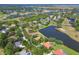 Aerial view of the home with surrounding community and a pond nearby at 7441 Myrica Dr, Sarasota, FL 34241