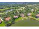 Aerial shot showcasing houses and water views surrounded by lush greenery and golf course at 7441 Myrica Dr, Sarasota, FL 34241
