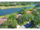 Aerial view of homes with tile roofs, beautiful lakes, and golf course at 7441 Myrica Dr, Sarasota, FL 34241