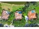 Bird's-eye view of tile-roofed houses with pools and mature landscaping at 7441 Myrica Dr, Sarasota, FL 34241