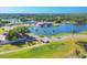 Beautiful aerial view of a golf course, pond, clubhouse, and surrounding lush landscaping at 7441 Myrica Dr, Sarasota, FL 34241