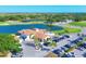 Expansive aerial of golf course community with a clubhouse, lake, and lush landscape at 7441 Myrica Dr, Sarasota, FL 34241