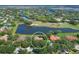 Aerial view of the home with a beautiful lake and golf course view at 7441 Myrica Dr, Sarasota, FL 34241