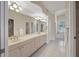 Large bathroom boasts dual sinks, vanity, tile flooring and walk-in shower at 7441 Myrica Dr, Sarasota, FL 34241
