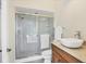 Bathroom featuring glass-enclosed shower, granite countertop, and modern fixtures at 7441 Myrica Dr, Sarasota, FL 34241