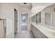 Bathroom featuring dual sinks, vanity, tile flooring and entrance to the pool area at 7441 Myrica Dr, Sarasota, FL 34241
