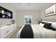 This is a beautifully designed bedroom with a Samsung Smart TV and a window view of green trees and lake at 7441 Myrica Dr, Sarasota, FL 34241