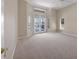 Spacious bedroom with carpet, neutral walls, a ceiling fan and a door leading to the pool at 7441 Myrica Dr, Sarasota, FL 34241