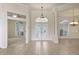 Spacious foyer with tile flooring, decorative glass front doors, and arched doorway at 7441 Myrica Dr, Sarasota, FL 34241