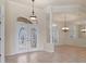 Welcoming foyer boasts decorative glass double doors, neutral color palette, and tile flooring at 7441 Myrica Dr, Sarasota, FL 34241