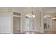 Welcoming foyer boasts decorative glass double doors, neutral color palette, and tile flooring at 7441 Myrica Dr, Sarasota, FL 34241