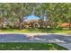 Charming one-story home with a tile roof, well-manicured lawn, and mature trees at 7441 Myrica Dr, Sarasota, FL 34241