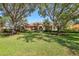 Beautiful single-story home with a tile roof, mature trees, and lush landscaping at 7441 Myrica Dr, Sarasota, FL 34241