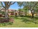 Inviting one-story house with tile roof and lush greenery, shaded by mature trees at 7441 Myrica Dr, Sarasota, FL 34241