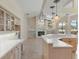 Open kitchen layout with tile floors and a view of the fireplace and pool area at 7441 Myrica Dr, Sarasota, FL 34241
