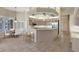 Open kitchen with barstools, stainless appliances, tile floors, and a large island at 7441 Myrica Dr, Sarasota, FL 34241