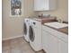 This laundry room features washer and dryer hookups and cabinetry at 7441 Myrica Dr, Sarasota, FL 34241