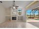 Open living room with fireplace, built-in shelves, and sliding door to a screened lanai and pool at 7441 Myrica Dr, Sarasota, FL 34241