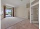 Expansive living area featuring neutral carpet, tile flooring, and sliding doors to patio at 7441 Myrica Dr, Sarasota, FL 34241