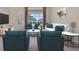 Comfortable living room features cozy seating, bright light, and view of pool area at 7441 Myrica Dr, Sarasota, FL 34241
