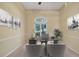 Bright office space with neutral colors, desk, art and window views at 7441 Myrica Dr, Sarasota, FL 34241